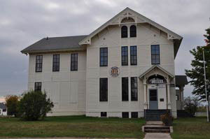 Large white two-story museum building with tall windows and an ornate entrance.