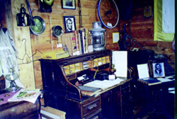 Historic desk and artifacts in Baraga County Museum’s cedar cabin, opened to preserve local history.