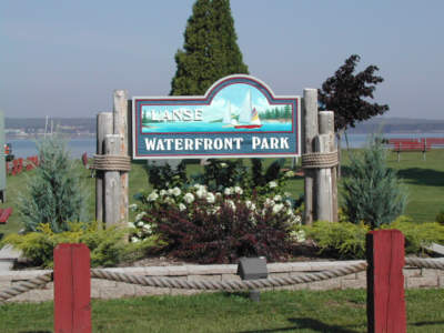 Large wooden L'Anse waterfront park sign.