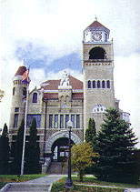 Crystal Falls Courthouse with tall bell tower, built with local materials and cultural tributes.