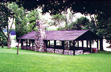  Rustic stone and log pavilion at Bewabic State Park.