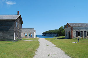 Historic buildings of Fayette on a path leading to Lake Michigan.
