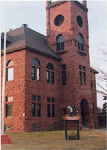  Gogebic County Courthouse, built in 1888 of red sandstone, with tall tower and arched windows.