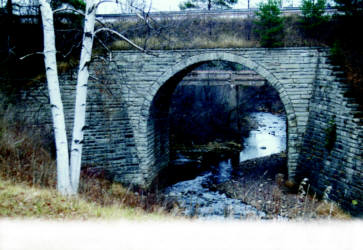  Stone arch railroad bridge over Black River, built in 1891 from Wisconsin limestone blocks.