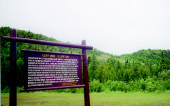  Historical marker for Cliff Mine and Clifton village, set in green hills of Michigan’s Keweenaw.