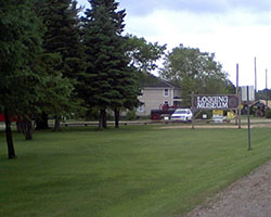 Entrance sign and grounds of the Tahquamenon Logging Museum.