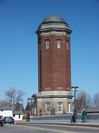 Octagonal red brick water tower in Manistique with a copper dome, built in 1922.